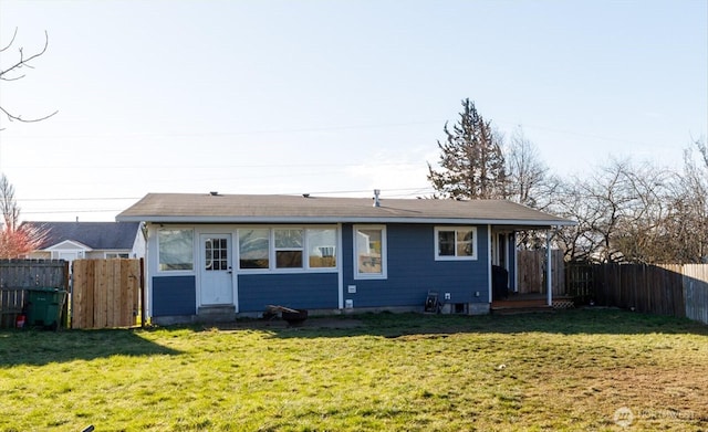 rear view of property with a lawn