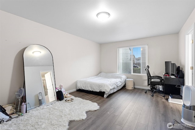 bedroom with dark hardwood / wood-style flooring