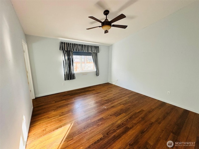 empty room with a ceiling fan and wood finished floors