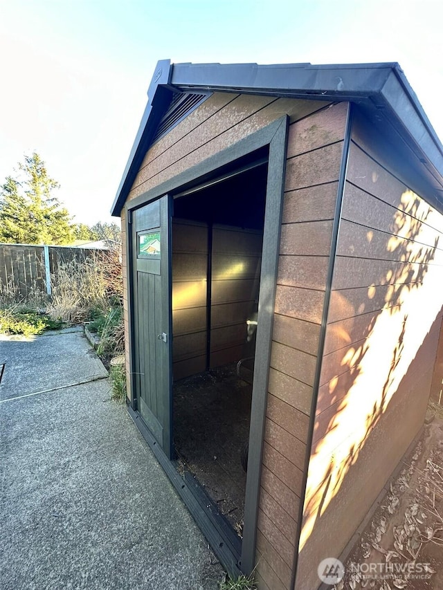 view of outbuilding featuring an outbuilding and fence