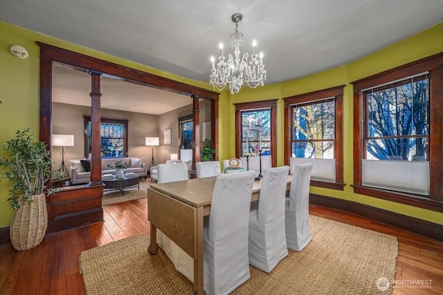 dining space with a chandelier and hardwood / wood-style floors