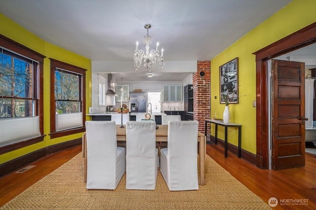 dining room featuring hardwood / wood-style floors and a chandelier