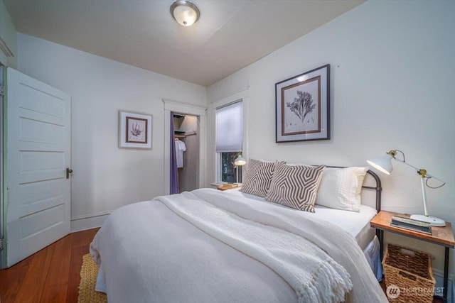 bedroom featuring a closet and dark hardwood / wood-style floors