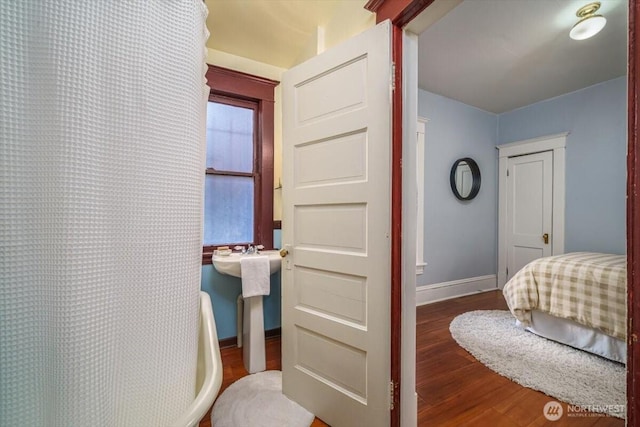 bedroom with hardwood / wood-style flooring