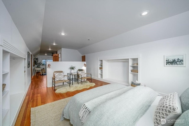 bedroom with hardwood / wood-style flooring and vaulted ceiling