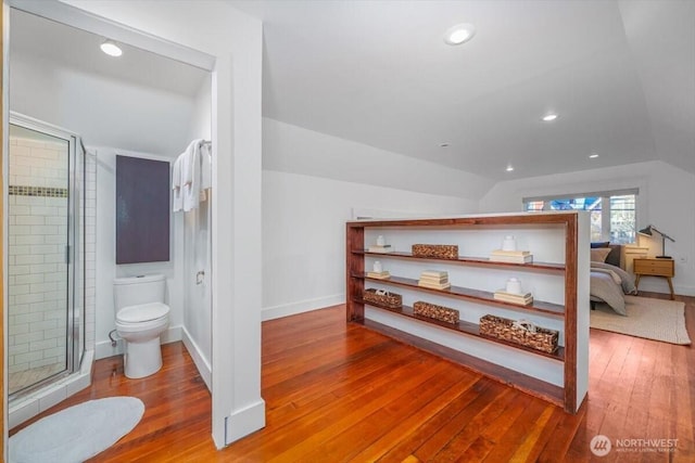 bathroom with lofted ceiling, wood-type flooring, and toilet