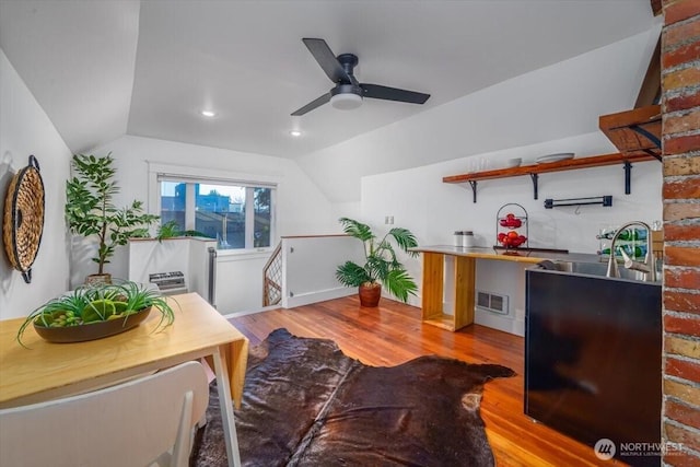 office space with ceiling fan, lofted ceiling, and light hardwood / wood-style floors