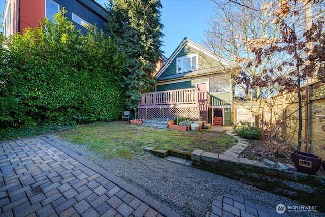 back of property with a wooden deck