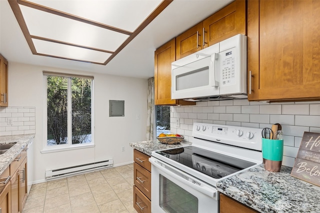 kitchen featuring baseboard heating, white appliances, light stone counters, and backsplash