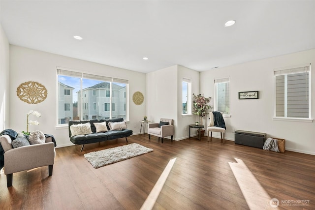 living room with a healthy amount of sunlight and dark hardwood / wood-style floors