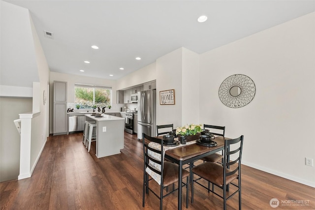 dining area with dark wood-type flooring