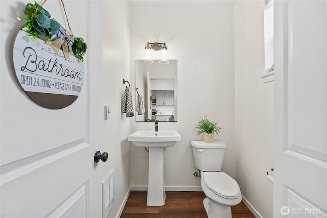 bathroom featuring toilet and hardwood / wood-style floors