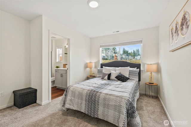 carpeted bedroom with connected bathroom