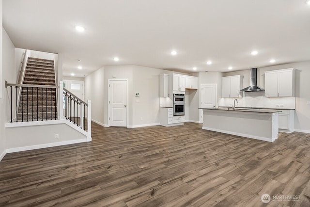 unfurnished living room with dark hardwood / wood-style flooring and sink