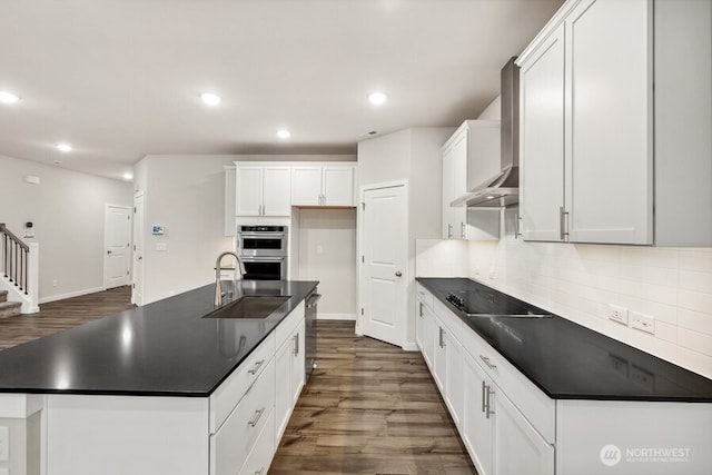 kitchen featuring white cabinetry, sink, black electric stovetop, and wall chimney exhaust hood