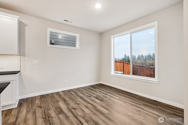 unfurnished dining area with hardwood / wood-style floors