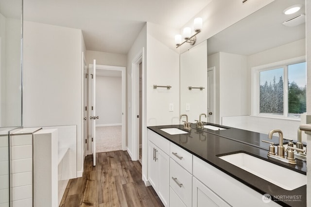 bathroom with vanity, a bathtub, and wood-type flooring