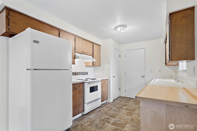 kitchen with sink and white appliances