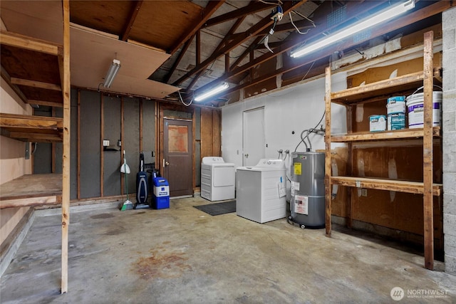 basement featuring water heater and independent washer and dryer