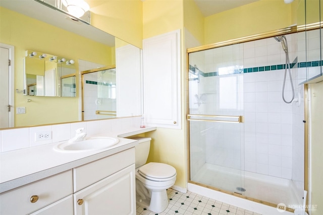 bathroom featuring an enclosed shower, vanity, and toilet