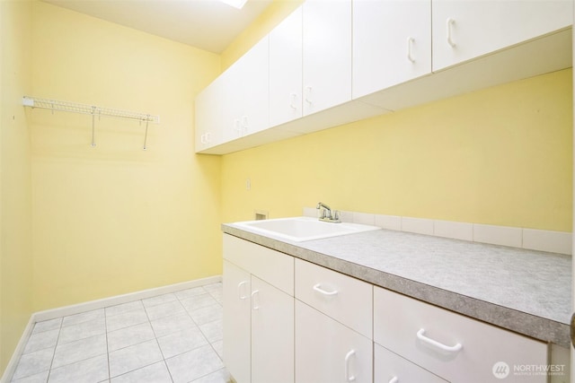 laundry area featuring cabinets, sink, hookup for a washing machine, and light tile patterned floors