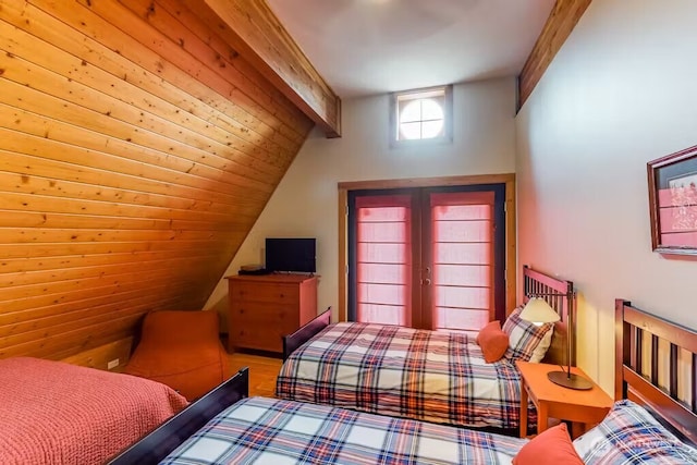 bedroom with vaulted ceiling with beams and french doors