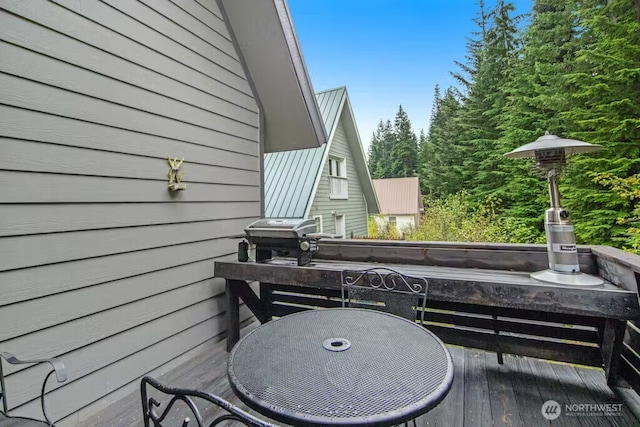 wooden terrace featuring a grill