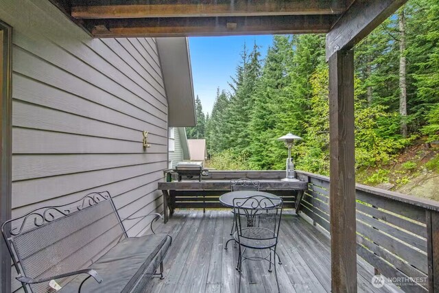 wooden terrace featuring grilling area