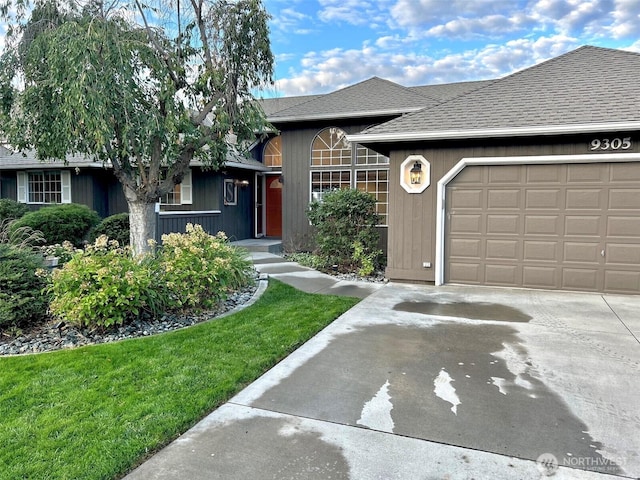 ranch-style house with a garage and a front yard