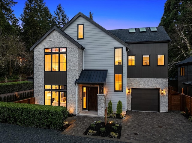 modern inspired farmhouse with a garage