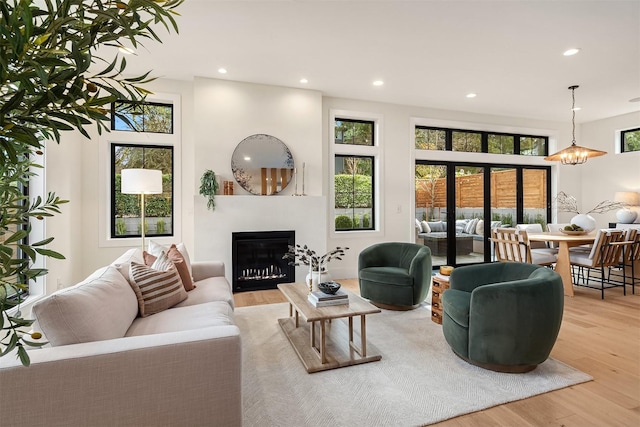 living room featuring a notable chandelier and light wood-type flooring