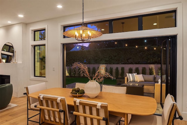 dining space with a chandelier and light wood-type flooring