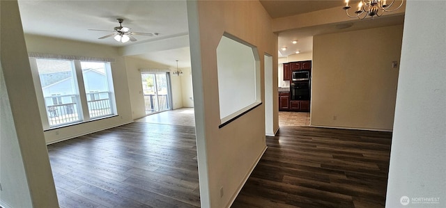 hall featuring a notable chandelier and dark hardwood / wood-style flooring