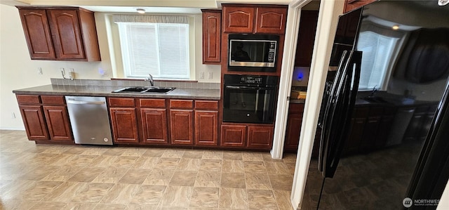 kitchen featuring built in microwave, sink, black oven, and dishwasher