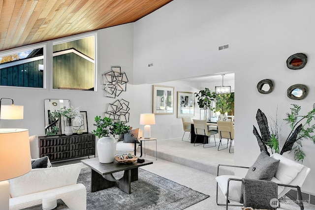 carpeted living room featuring wood ceiling and high vaulted ceiling