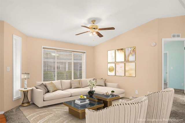 carpeted living room featuring vaulted ceiling and ceiling fan