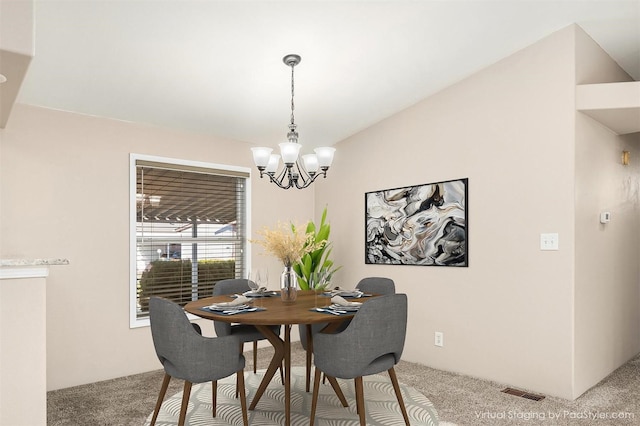 dining room featuring a chandelier and carpet