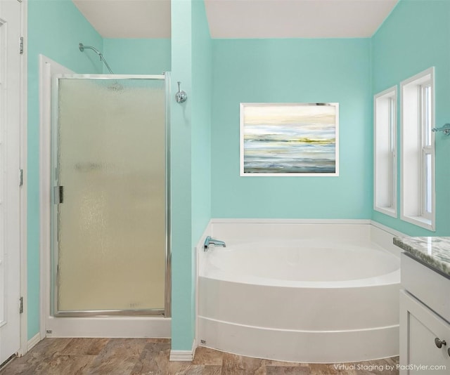 bathroom featuring vanity, separate shower and tub, and plenty of natural light