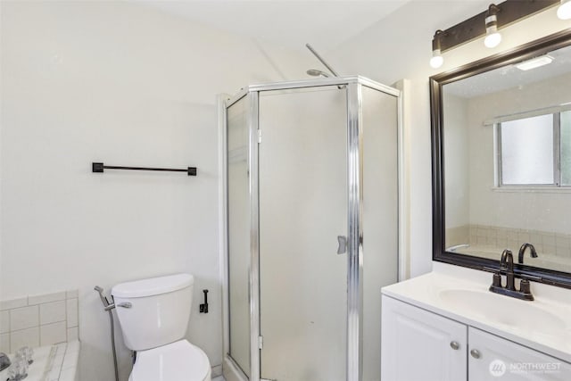 full bathroom with toilet, a shower stall, vanity, and a bath