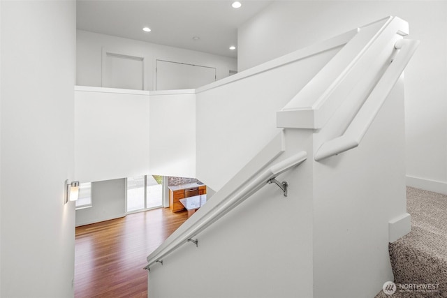 staircase featuring wood-type flooring