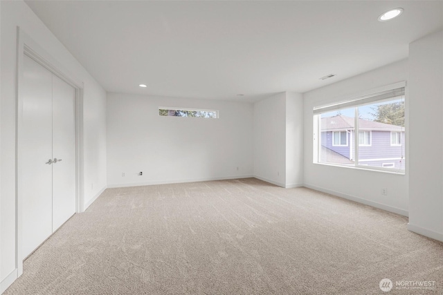 spare room with light colored carpet