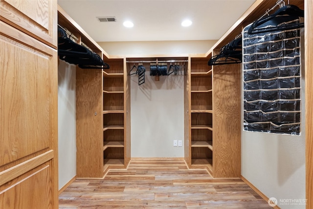 walk in closet featuring wood finished floors and visible vents