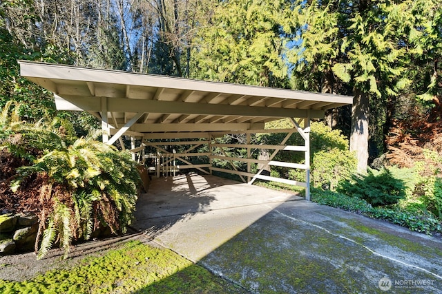 view of parking / parking lot with driveway and a detached carport