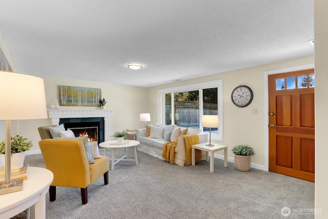 carpeted living room with a fireplace and a textured ceiling