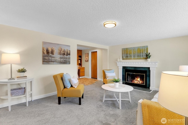 living room featuring a premium fireplace, carpet flooring, and a textured ceiling