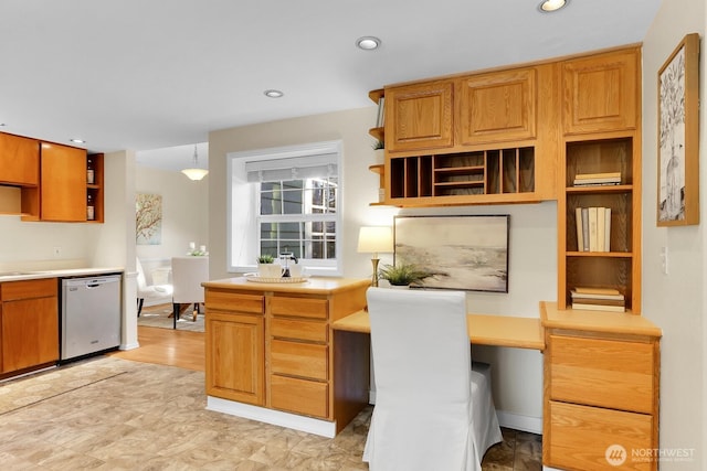 kitchen with hanging light fixtures, built in desk, and stainless steel dishwasher