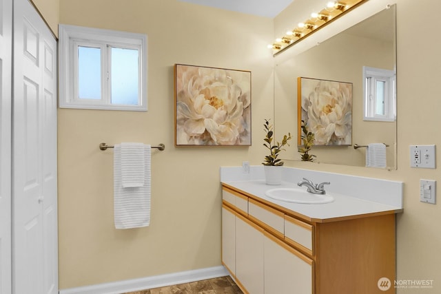 bathroom with plenty of natural light and vanity