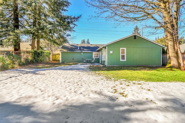 rear view of house with a lawn