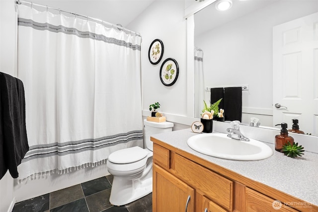 full bathroom featuring shower / bathtub combination with curtain, vanity, and toilet