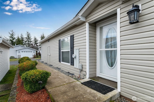 property entrance with a detached garage